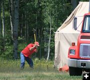 Pounding tent stake. Photo by Dawn Ballou, Pinedale Online.