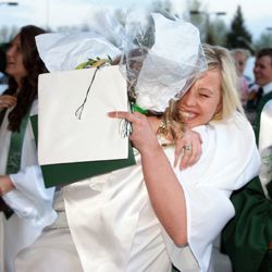 Pinedale graduation. Photo by Graduating senior Sara Ritschel gives a fellow graduate a great big bear hug after the Pinedale High School commencement ceremony last Friday. Seventy-one seniors emerged from the Wrangler Gym, diploma in hand, into the dawn of the rest of their lives. While not all will follow the traditional path of going to college, each one of them is destined for an adventure. Photo by Megan Rawlin, Pinedale Roundup.