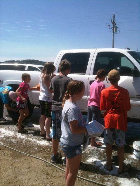 Cleaning the trucks. Photo by Ranae Pape, Sublette County Extension Office.