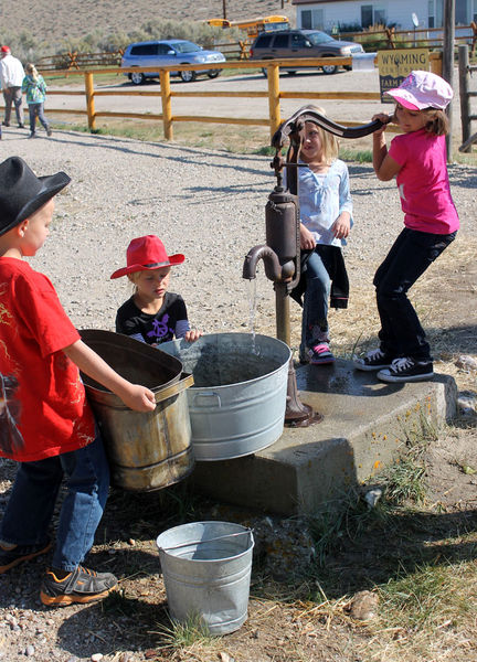 Filling buckets. Photo by Clint Gilchrist, Pinedale Online.
