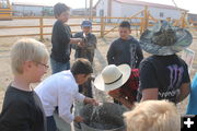Tasting the well water. Photo by Dawn Ballou, Pinedale Online.
