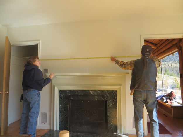 Measuring above fireplace. Photo by Jonita Sommers.