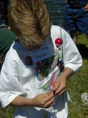 Putting a worm on a fishing hook. Pinedale Online photo.