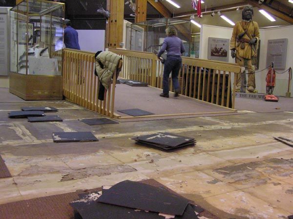 Removing carpet squares. Photo by Pinedale Online.