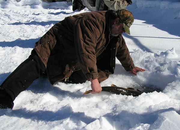 Joe releases his fish. Photo by Bill Boender.