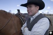 Roper Joe Gillis waits to mount his steed so that he can throw his rope around. Photo by Tara Bolgiano.