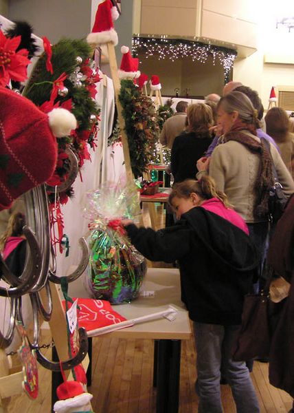 Looking at all the wreaths. Photo by Dawn Ballou, Pinedale Online.