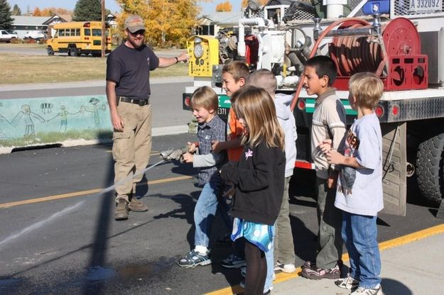 Spraying the fire hose. Photo by US Forest Service.