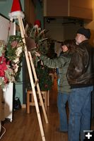 Looking at wreaths. Photo by Dawn Ballou, Pinedale Online.