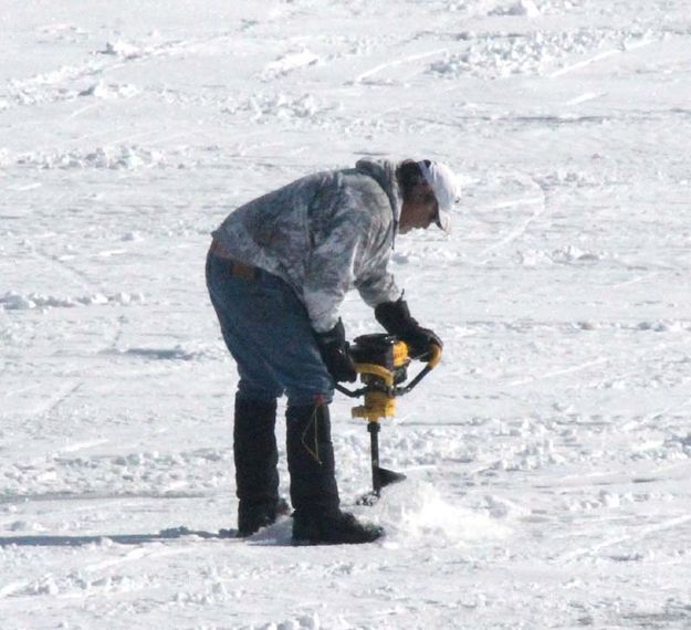 Drilling a fishing hole. Photo by Dawn Ballou, Pinedale Online.