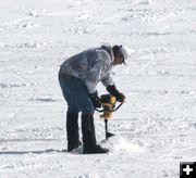 Drilling a fishing hole. Photo by Dawn Ballou, Pinedale Online.