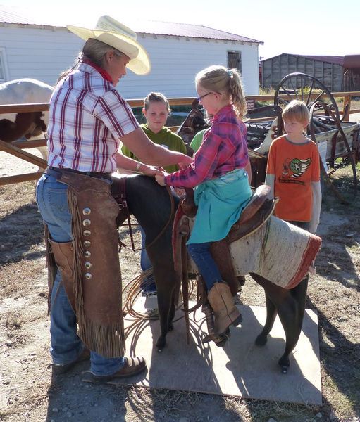 Saddling a horse. Photo by Clint Gilchrist.