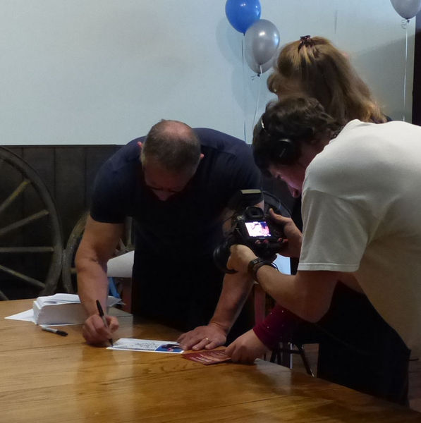 Signing autographs. Photo by Dawn Ballou, Pinedale Online.