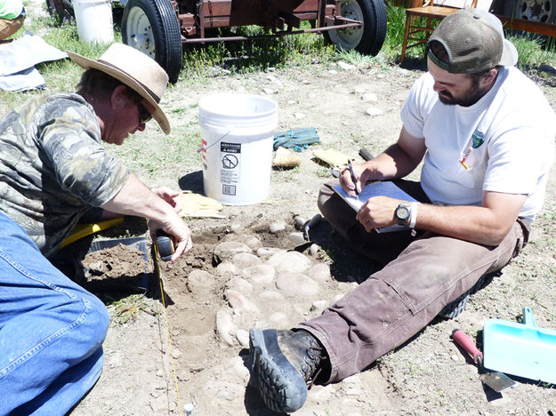 Taking measurements. Photo by Dawn Ballou, Pinedale Online.