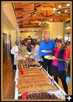 Rick and Sue in Food Line. Photo by Terry Allen.